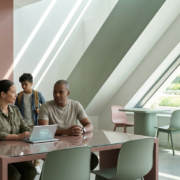a family sits at a kitchen table, deep in conversation, hinting at mental health support.