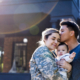military spouse in uniform embracing her baby, husband kisses her forehead, support for military families