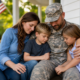 veteran in camouflage with wife and two children, illustrating emergency veteran family support.