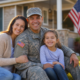 smiling military family, father in uniform, in lawn for veteran family assistance 2026.
