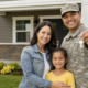 military veteran family smiling with keys to their new home, supported by veteran transitional housing grants.