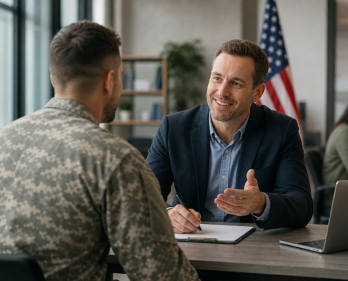 smiling man in suit helping a veteran in uniform with unemployed veterans programs paperwork.