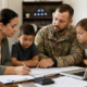 military veteran and family reviewing documents and laptop, utilizing veteran family support services.
